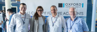 Attendees at the 15th Identity & Cloud Summit 2024 in front of the Oxford Computer Group stand in Erding
